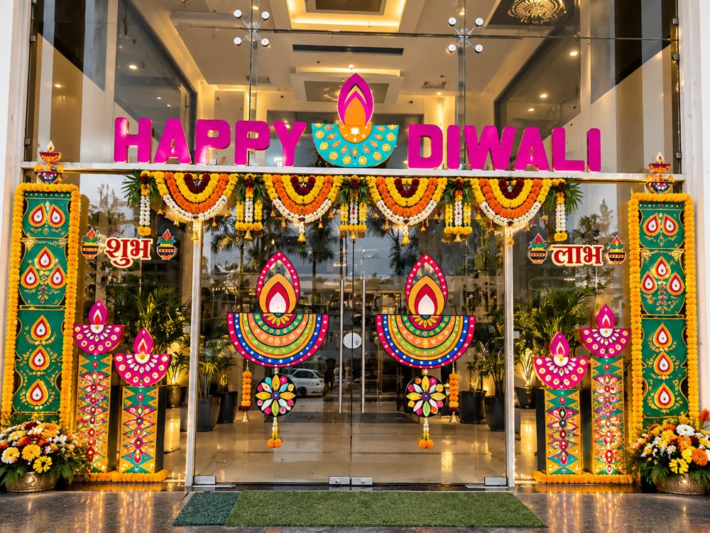 Diwali decor: Happy Diwali entrance with diya cutouts, marigold toran and floral arrangements