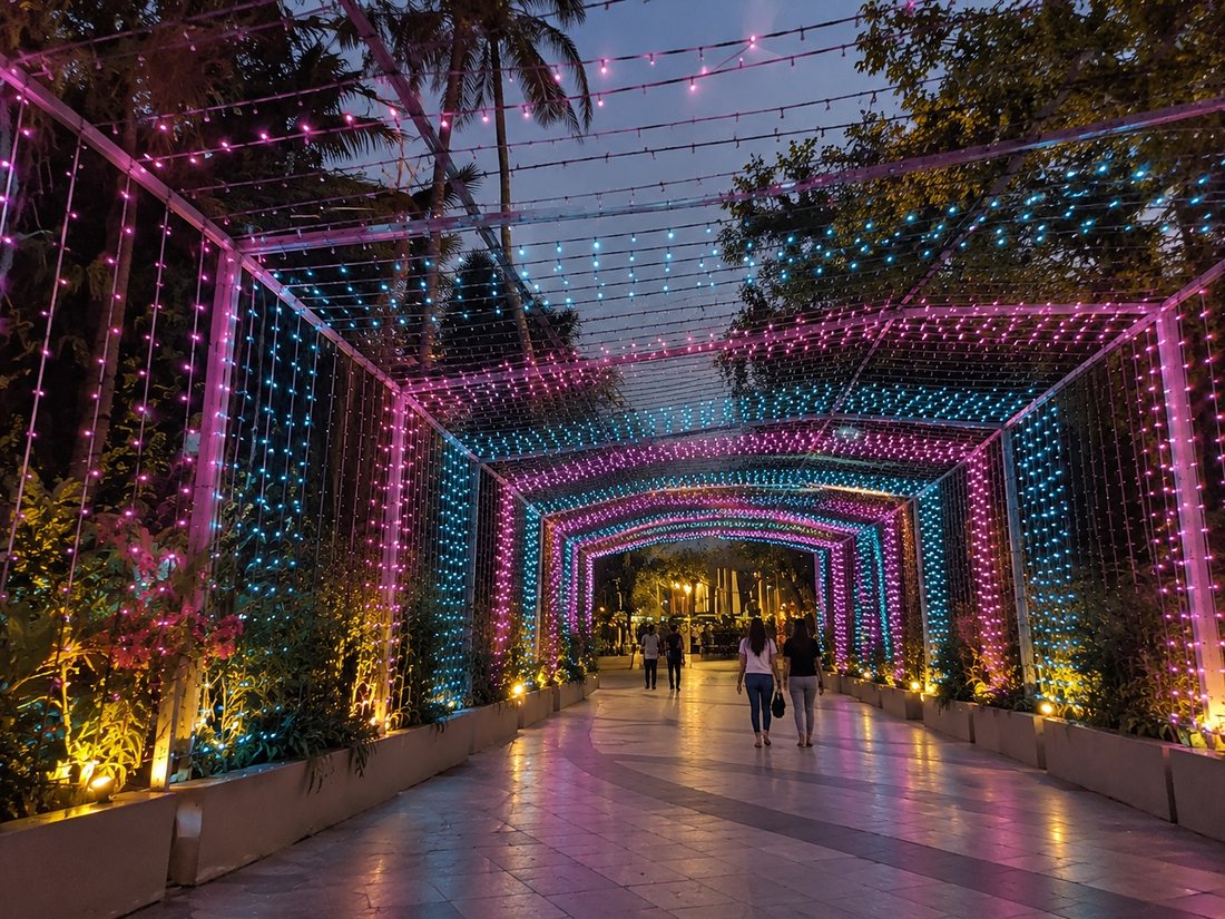 New Year decor: tunnel of pink and blue fairy lights over a walkway